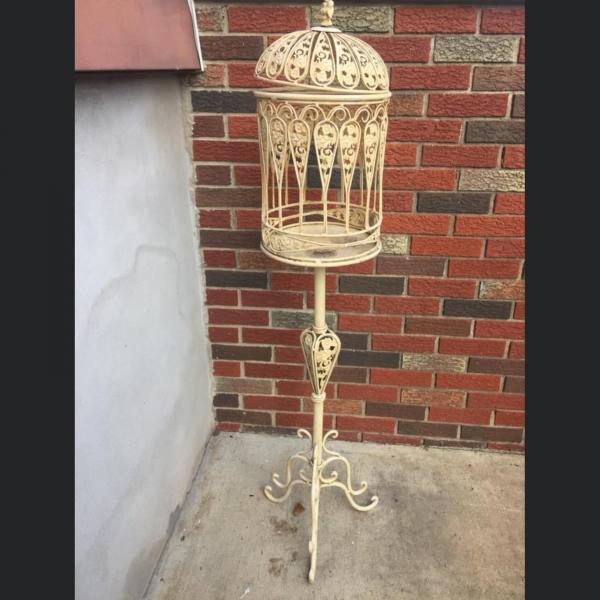 Photo of Antique birdcage metal frame on pedestal