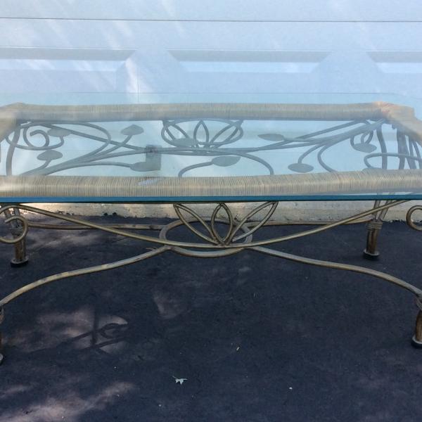 Photo of Glass top metal and rattan coffee table