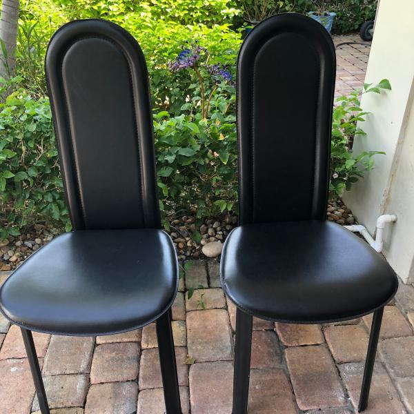 Photo of 2 black leather chairs
