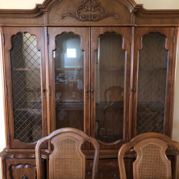 Photo of Wood dinning room table with matching hutch
