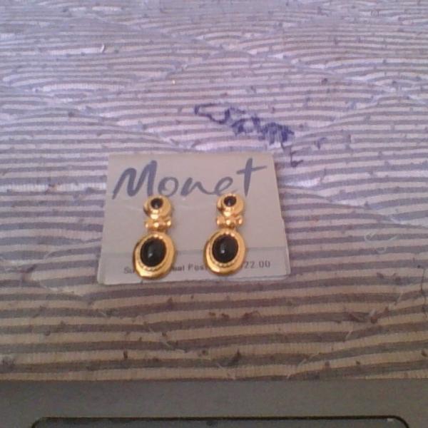 Photo of a pair  of brown and black ear rings 