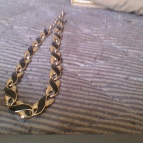 Photo of A gold and black necklace 