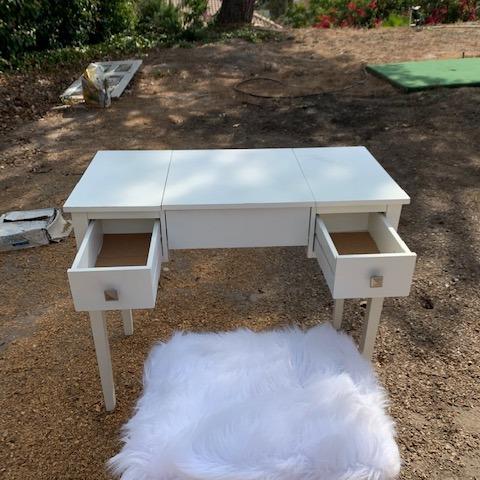 Photo of White vanity with faux fir stool