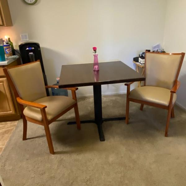 Photo of Small kitchen or bar table with 2 chairs with arms