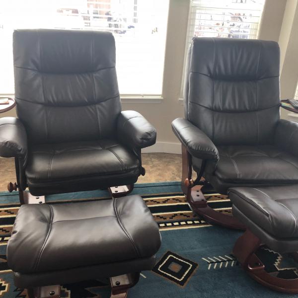 Photo of Two leather recliners with footstools