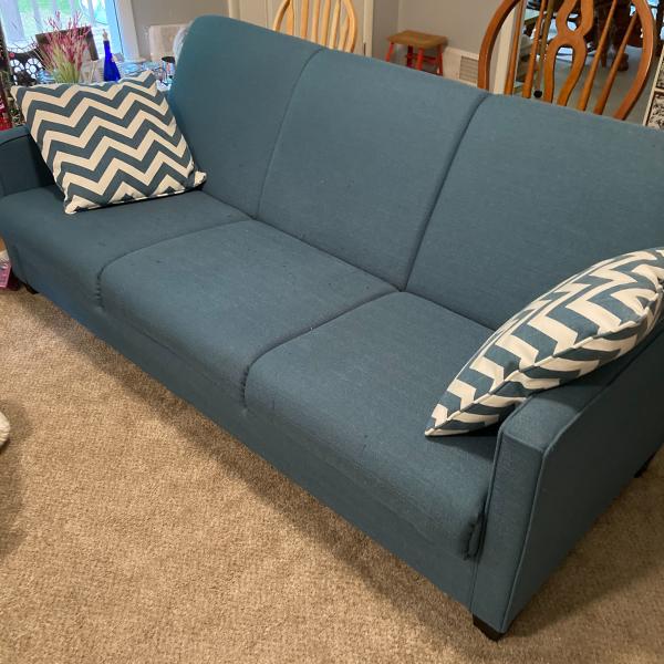 Photo of Teal blue sofa and bed