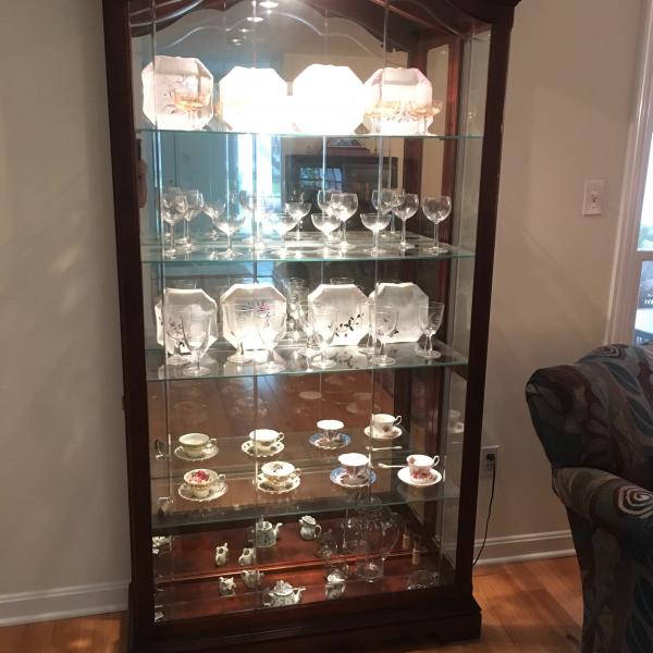 Photo of Howard Miller curio,cherry wood, lit, and beveled glass front, like new