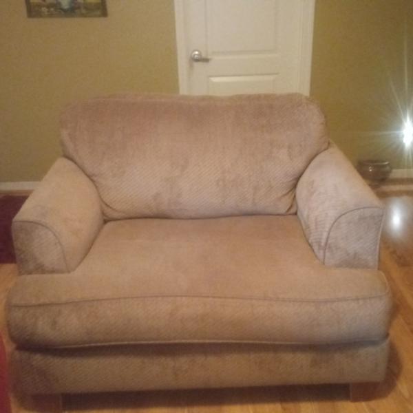 Photo of Beige overstuffed chair. Good condition.