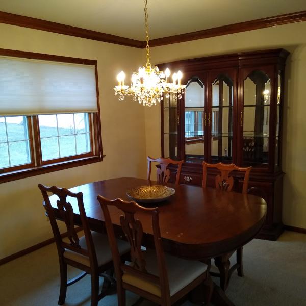Photo of Wood Dining Room table with 6 chairs and an extra leaf.