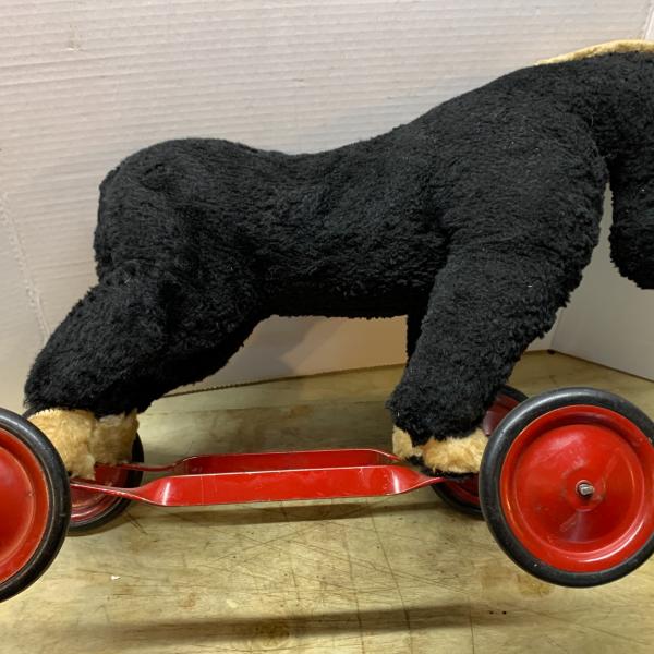 Photo of Old riding toy horse on wheels 