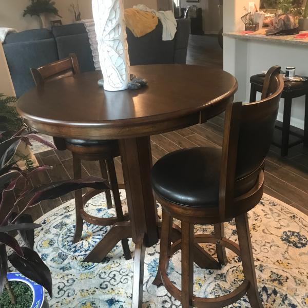 Photo of Pub table and two high back swivel barstools