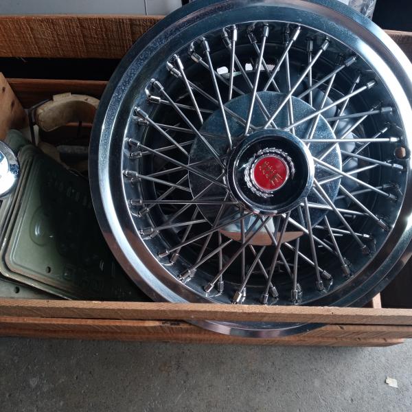 Photo of Wire wheel hub caps. Some old plates and caps
