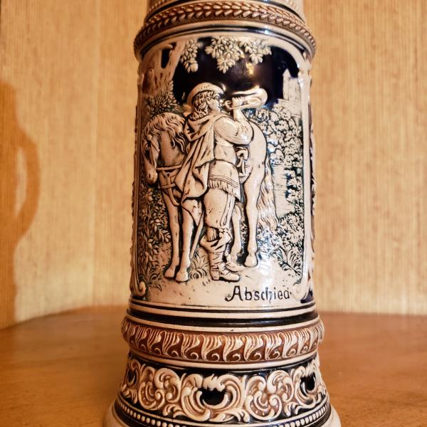 Photo of Vintage German Stein Features a Detailed Scene Horse Rider Blowing His Trumpet.
