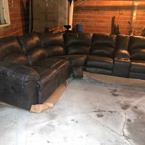 Photo of Ashley leatherette wall sectional 