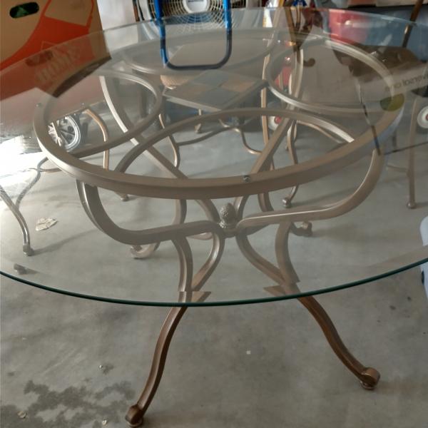 Photo of Glass top table with four chairs