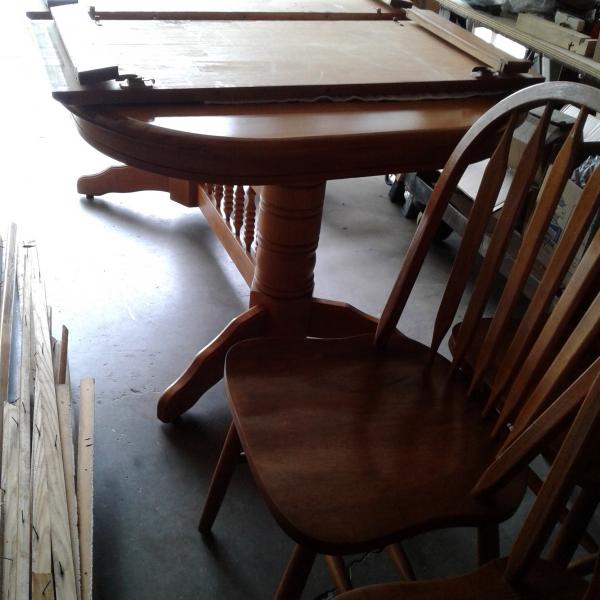 Photo of Large dinning room table six chairs and two leafs solid heavy table. 
