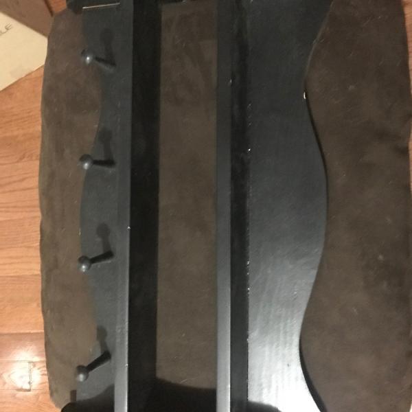 Photo of Black wooden shelves with post to hang clothing or tools etc