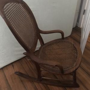 Photo of 1890’s small cane rocking chair. The seat needs caning .