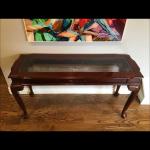 Brown wood console table with glass insert