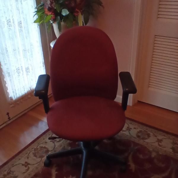 Photo of Maroon office chair with arms and wheels