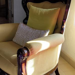 Photo of Upholstered wooden accent chair with decorative pillows