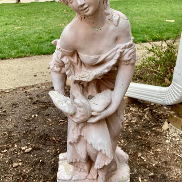 Photo of Concrete Girl Statue with Dove