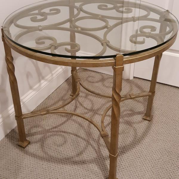 Photo of Glasstop round decorative metal base table