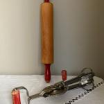 2 items: ANDROCK hand mixer/egg beater and unmarked rolling pin red handles