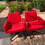 Two Red Swivel Office Chairs