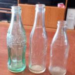 Antique Coca Cola, Dr Pepper, and Pepsi bottles