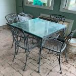 Vintage square black iron patio table with glass top and four chairs