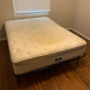 Photo of queen sized bed with frame
