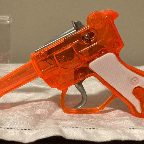 Photo of Vintage a toy JA-RU cap gun, orange white, made of plastic, China