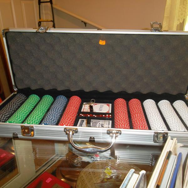 Photo of Heavy clay poker cips in metal carring case with accessories.