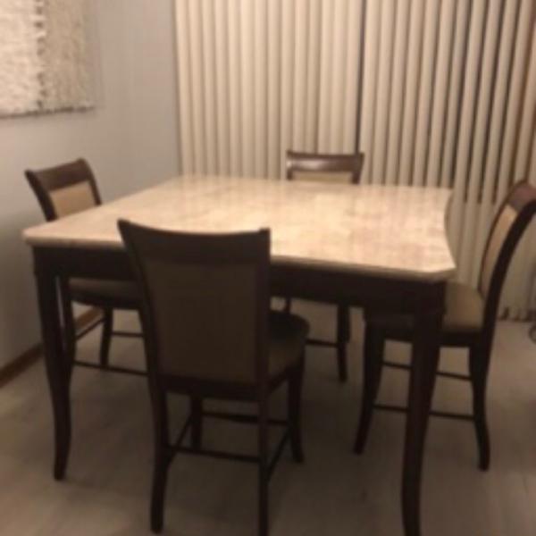 Photo of Marble top  and 6 chairs wood legs .