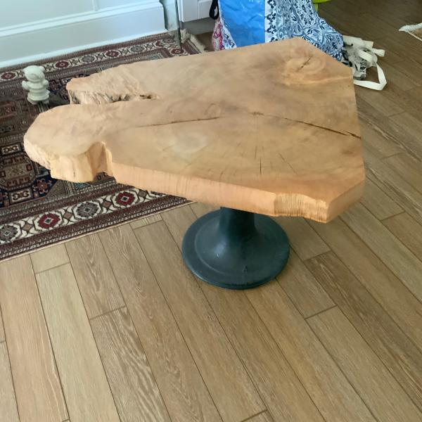 Photo of Lovely raw edge wood table on iron base.