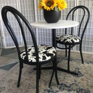 Photo of Table and two Chairs-cow print