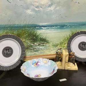 Photo of Vintage Plates and Marble Hold Books