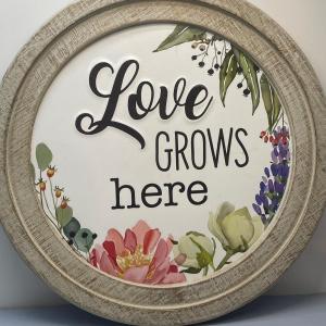 Photo of Metal sign- "Love grows here"