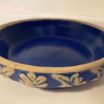Blue stoneware pie   plate with floral leaf border marked 8 on bottom