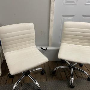 Photo of Wheeled white leather chairs