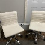 Wheeled white leather chairs