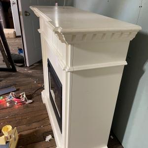 Photo of Working Heater with white fireplace mantle