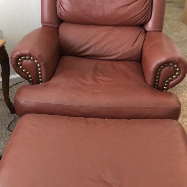 Photo of Beautiful leather chair and footstool 