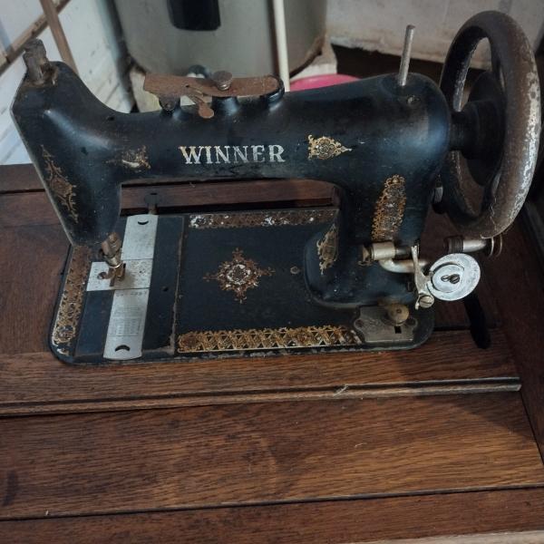 Photo of Antique Winner Sewing Machine/treadle and table