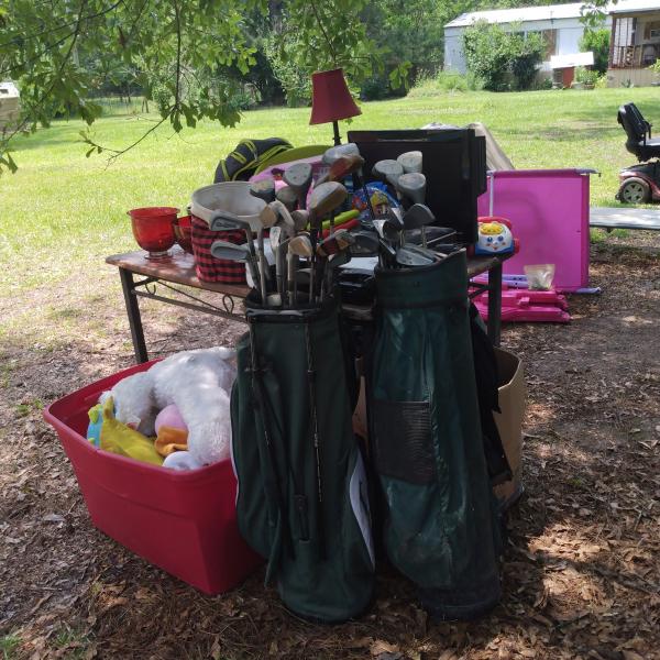 Photo of Golf bags with clubs.   Lift to carry on back of vehicle 
