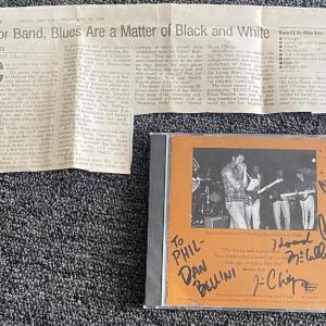 Photo of Howard & The White Boys signed CD with newspaper clipping 