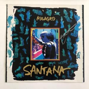 Photo of Santana Milagro album flat signed by Carlos Santana