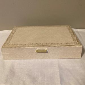 Photo of MELE ivory off white color gold accent, blue inside jewelry box   