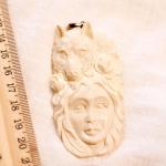 Carved bovine bone woman with wolf & horse pendant